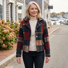 Woman wearing the Ariella plaid wool button-down jacket over a cream turtleneck on a coastal street