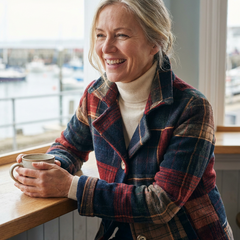 Close view of the Ariella plaid wool jacket worn at a cafe, showing the wool texture and notched collar